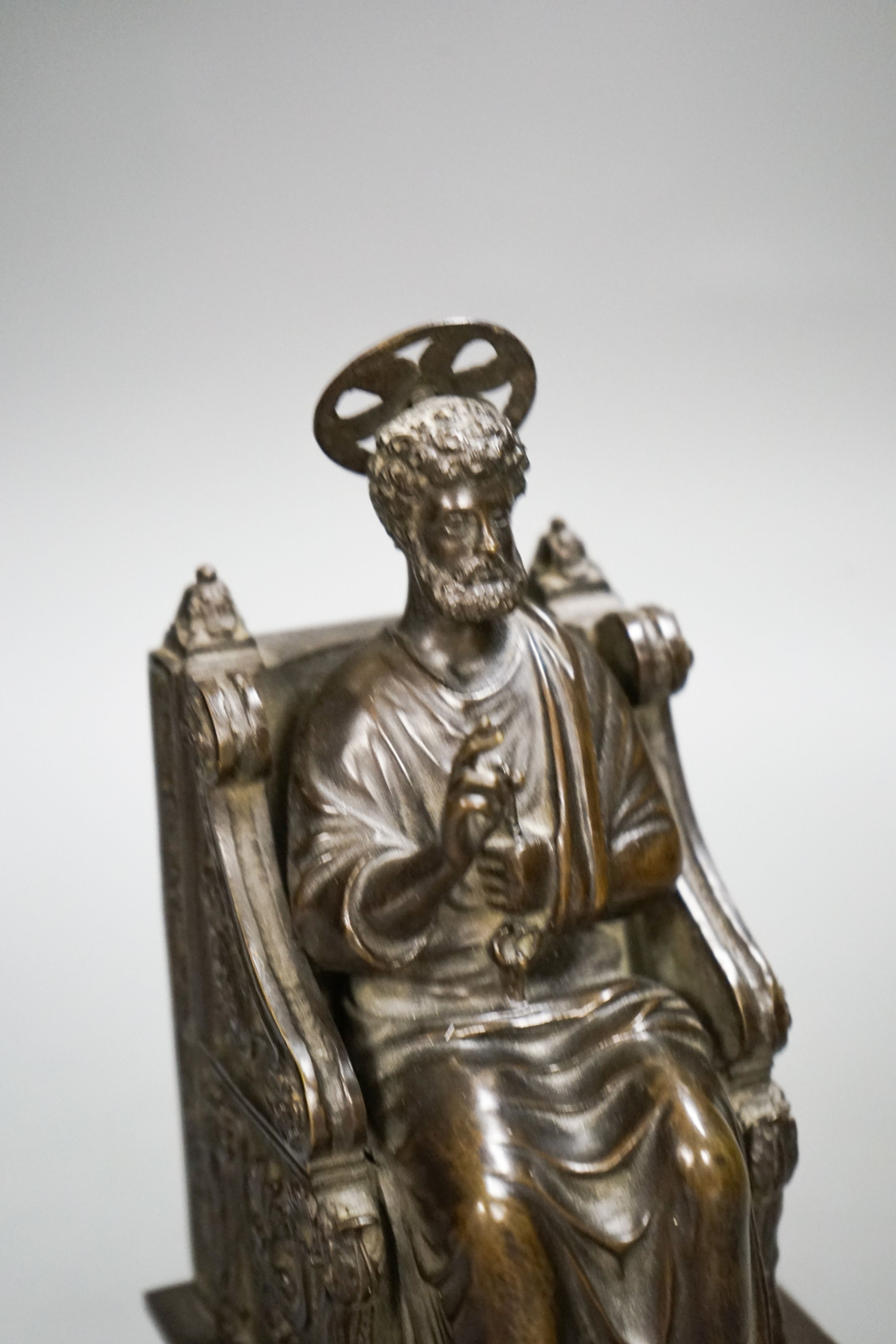 A late 19th century bronze figure of St. Peter seated on a throne, 22cm